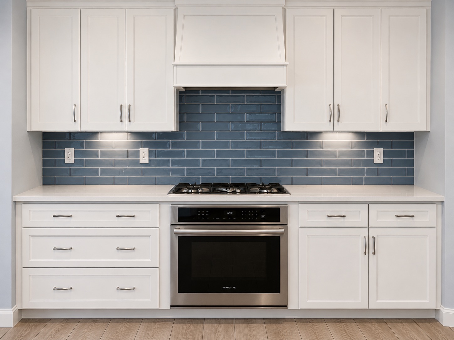 Kitchen remodeled by Reyes Flooring and Design with navy cabinets, marble countertop and gold accents