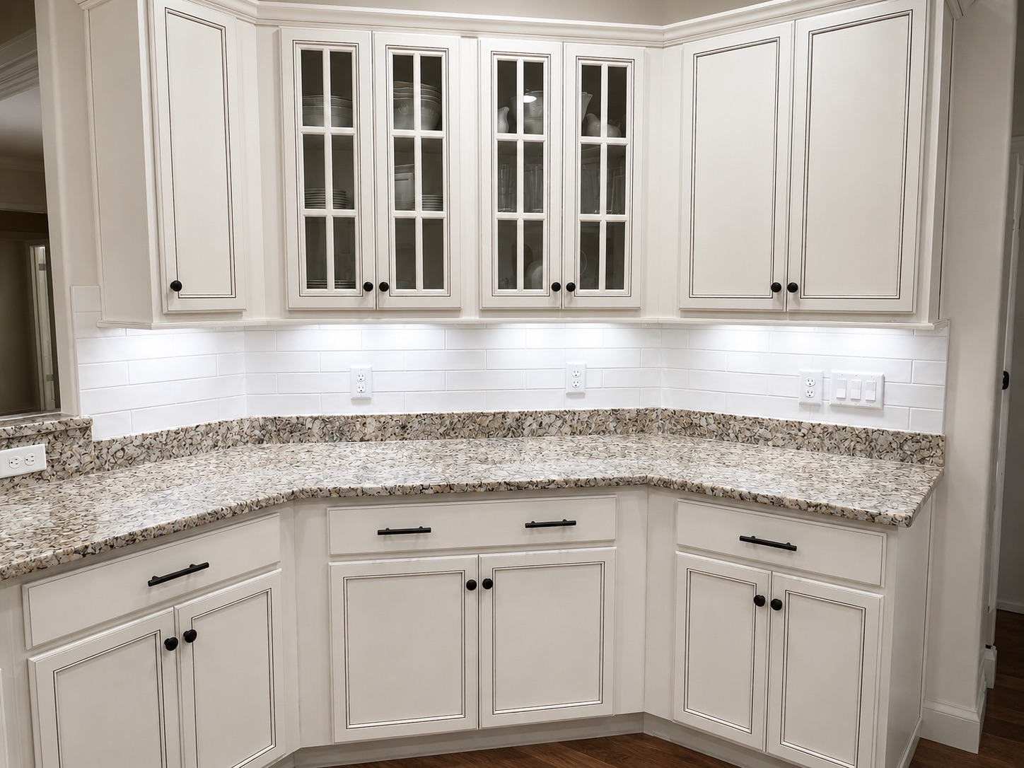 Kitchen with white cabinets, granite countertop and subway backsplash