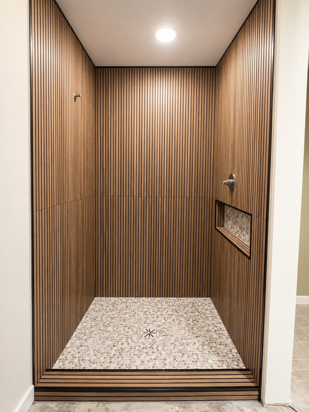 Shower with fluted wood panels and polished stone floor