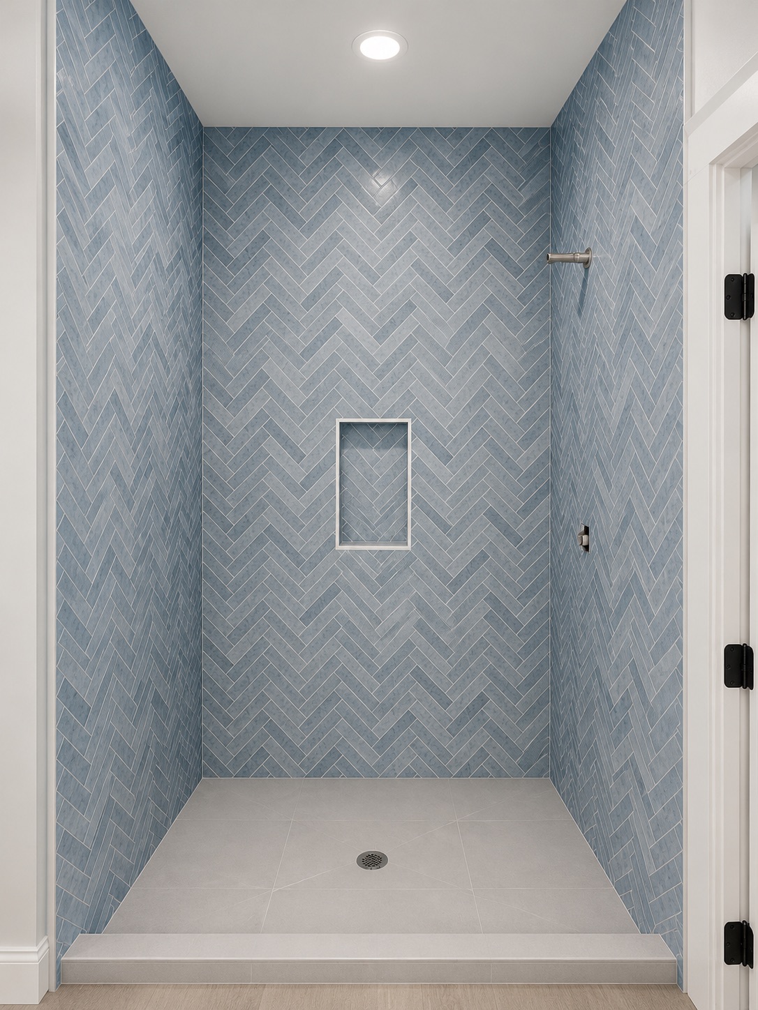 Shower with blue herringbone tile and recessed niche